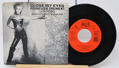 Vinyl record with cover featuring a woman and text, on a white background