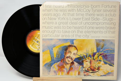 Vinyl record with a colorful cover featuring a man and text on a light gray background