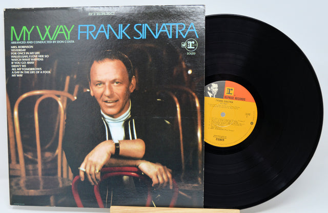 Vinyl record and cover of 'My Way' by Frank Sinatra on a light blue background