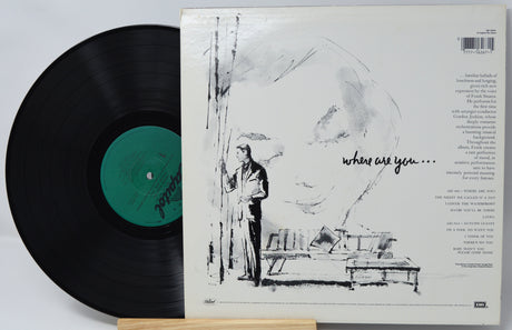 Vinyl record with a black cover featuring a drawing of a person and text.