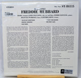 The back cover of a Blue Note CD release for Freddie Hubbard, showing track listings, credits, and a small Blue Note logo sticker in the bottom right corner, photographed resting on a wooden surface.