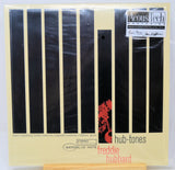 Acous Tech Mastering 'hub-tones' album vinyl record sleeve for 'freddie Hubbard', featuring a cream-colored background with vertical black stripes and a red graphic, photographed in its plastic shrink wrap.