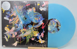 Front cover and azure blue vinyl of The Third Chimpanzee limited edition EP by Martin Gore, with vibrant brushstroke art