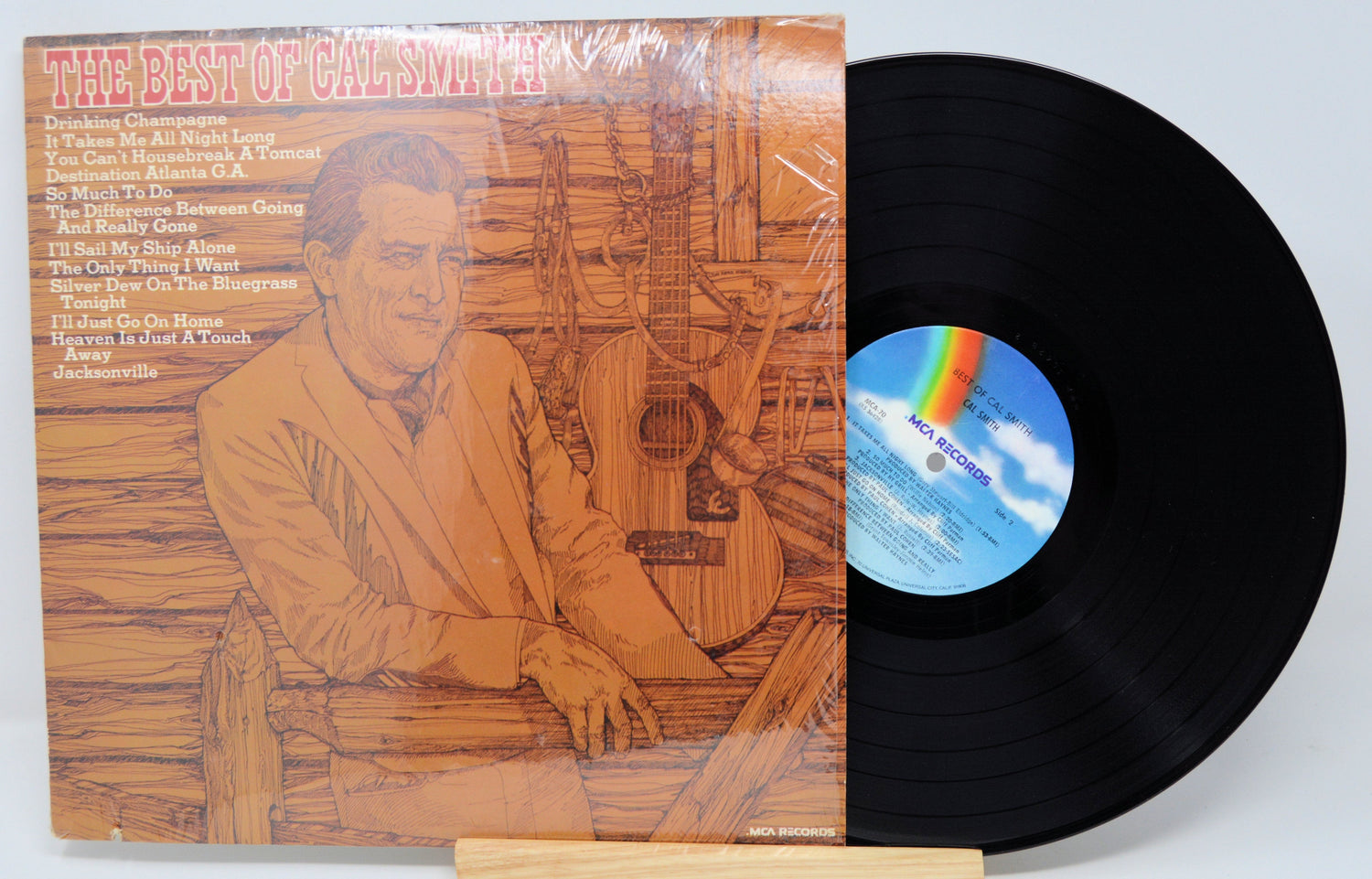 Front cover and record of 'The Best of Cal Smith' vinyl LP with illustrated portrait and tracklist