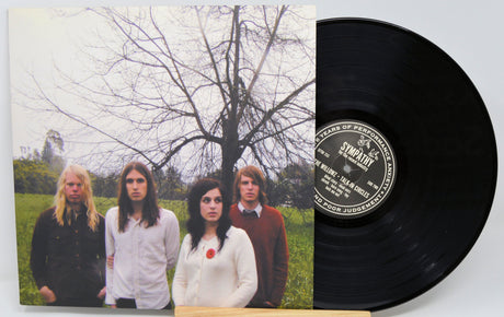 The Willowz Talkin' Circles album front cover featuring band members standing by a tree with vinyl record partially out