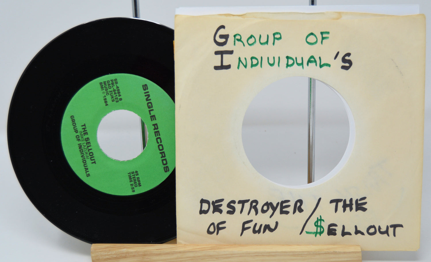 Vinyl record with a green label and wooden sleeve labeled 'Group of Individual's' on a white background.