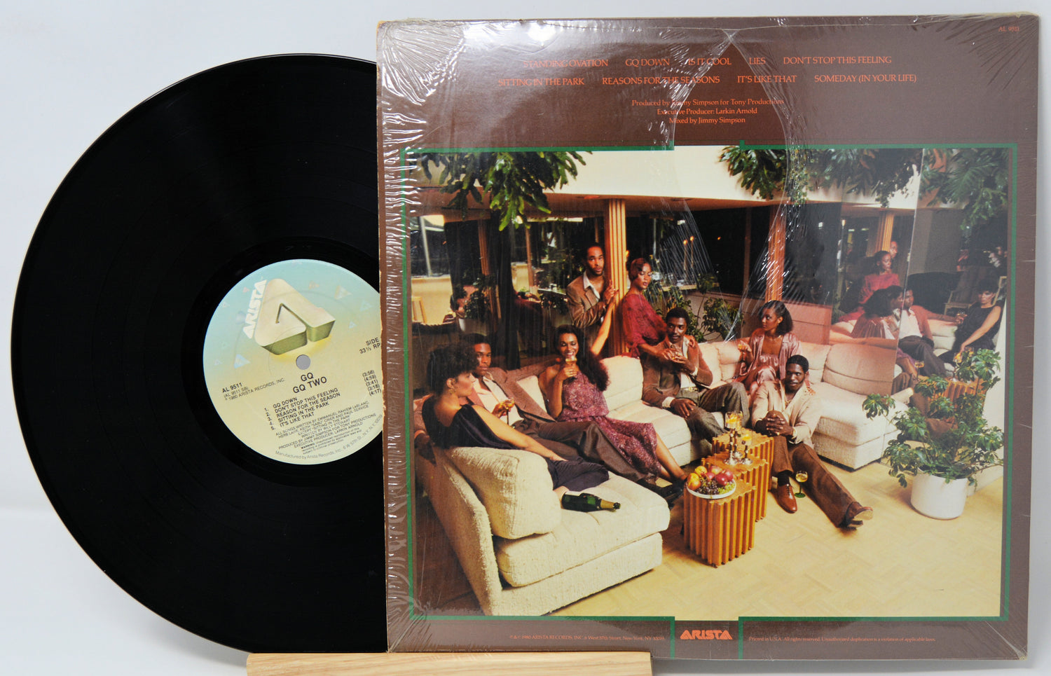 Vinyl record with cover showing a group of people in a living room setting