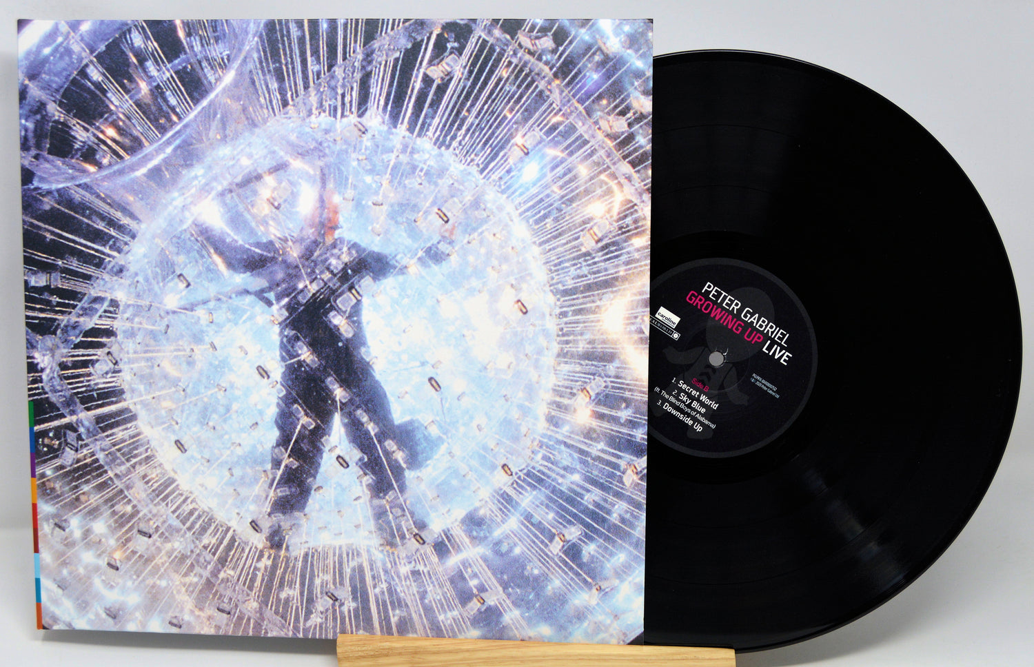 Vinyl record and cover with a person in a circular design, featuring the artist's name on the record.