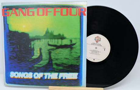 Vinyl record with 'Gang of Four' album cover showing a landscape and boat.