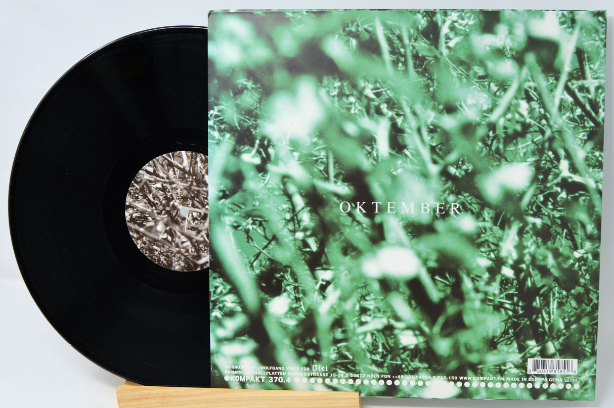 Vinyl record with a green cover featuring the word 'Oktober' on a white background