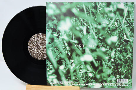 Vinyl record with a green cover featuring the word 'Oktober' on a white background