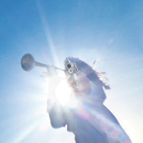 Silhouette of a person with a helmet against a bright blue sky