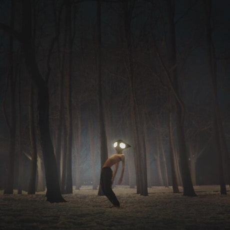 Person with glowing eyes walking through a dark forest