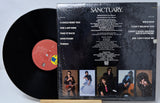 Vinyl record with cover featuring album tracklist and promotional images on a light gray background