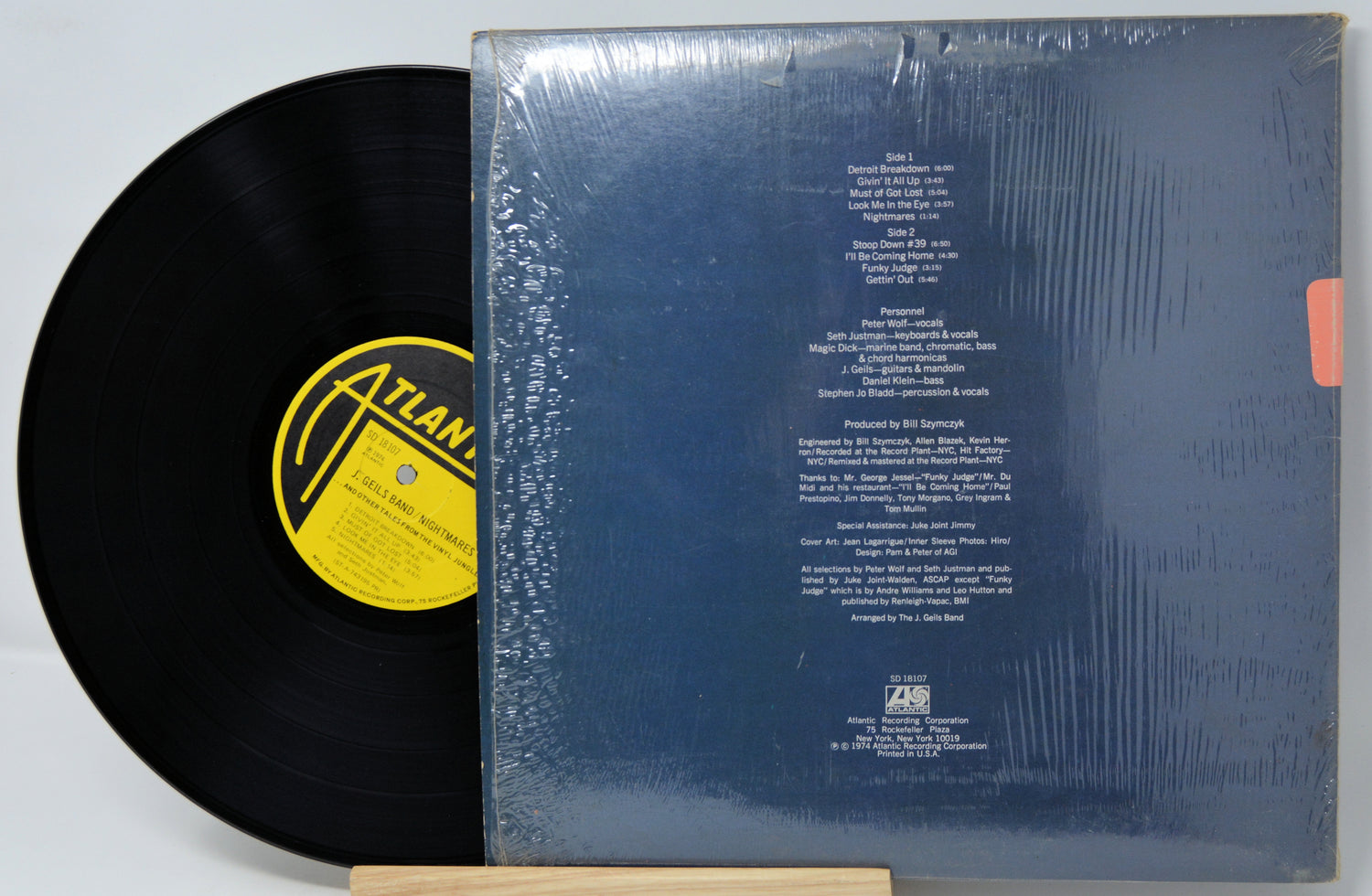 Vinyl record with a visible label and cover on a light gray background