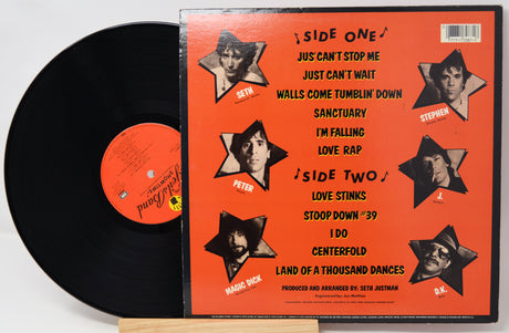 Vinyl record with orange cover featuring star-shaped cutouts of a person's face and text.