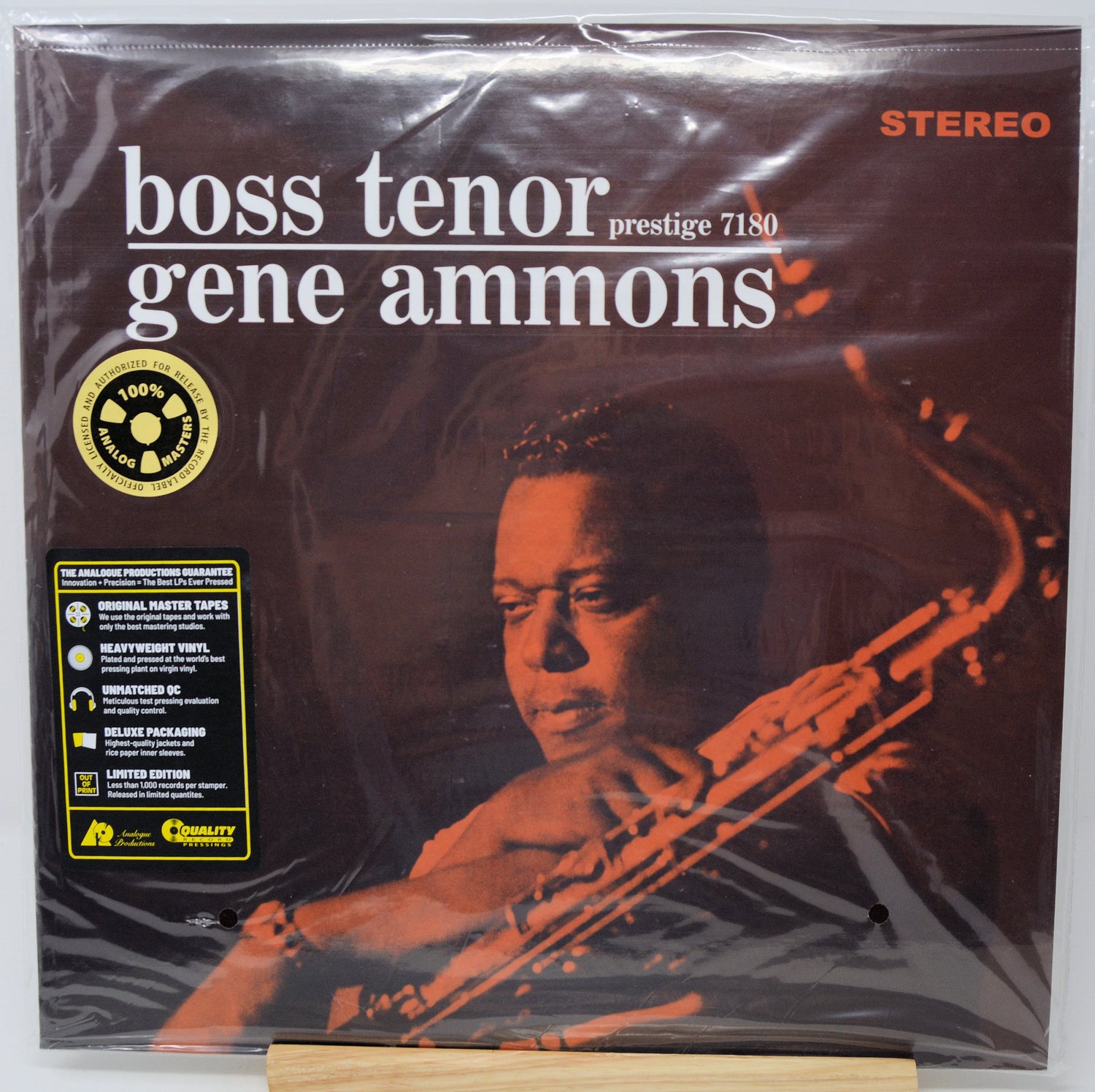 Gene Ammons 'Boss Tenor' Prestige 7180 vinyl record LP in its original shrink wrap, displayed on a wooden stand against a white background.