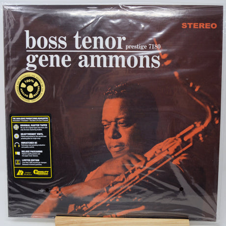 Gene Ammons 'Boss Tenor' Prestige 7180 vinyl record LP in its original shrink wrap, displayed on a wooden stand against a white background.