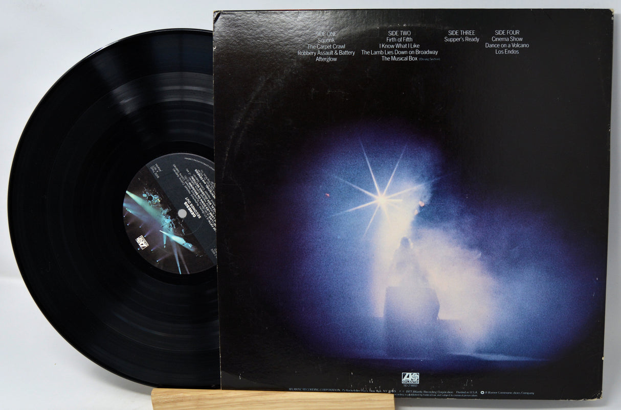 Vinyl record and cover with a person holding a light bulb on a dark background