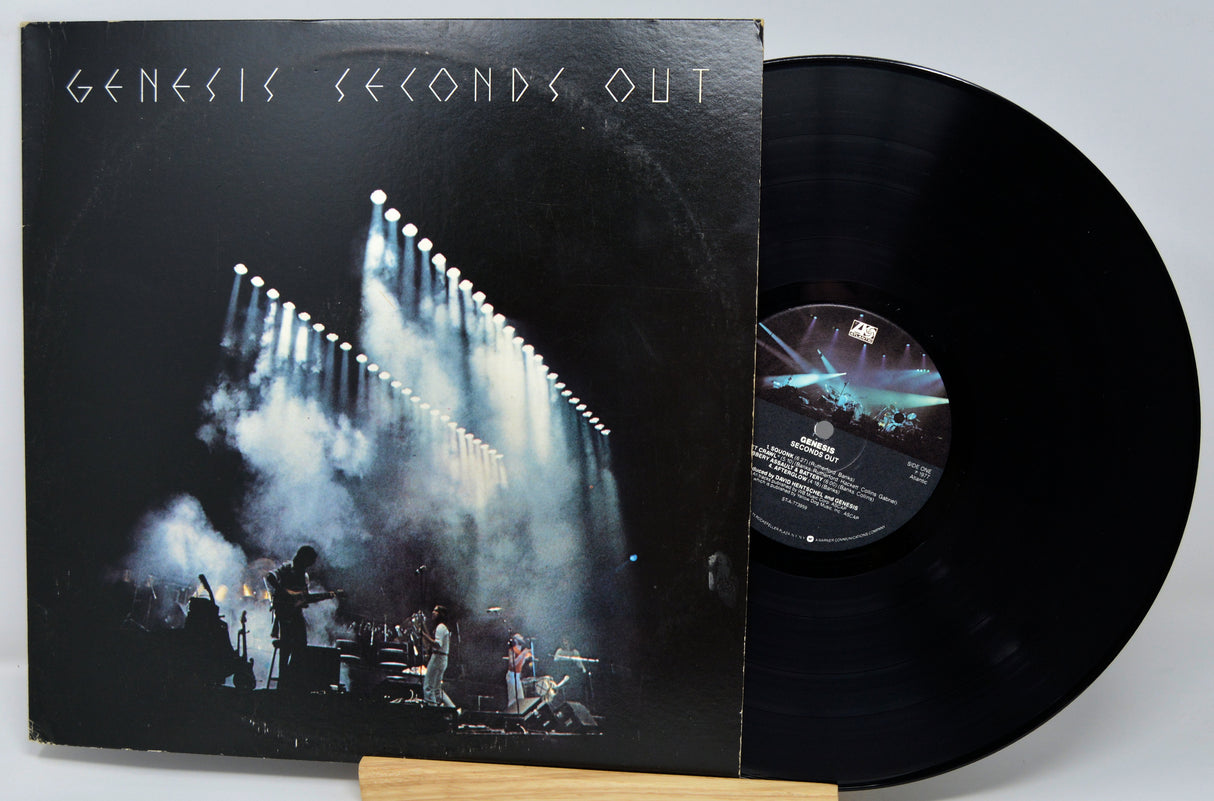 Vinyl record with cover featuring a band on stage and 'Genesis Seconds Out' text.