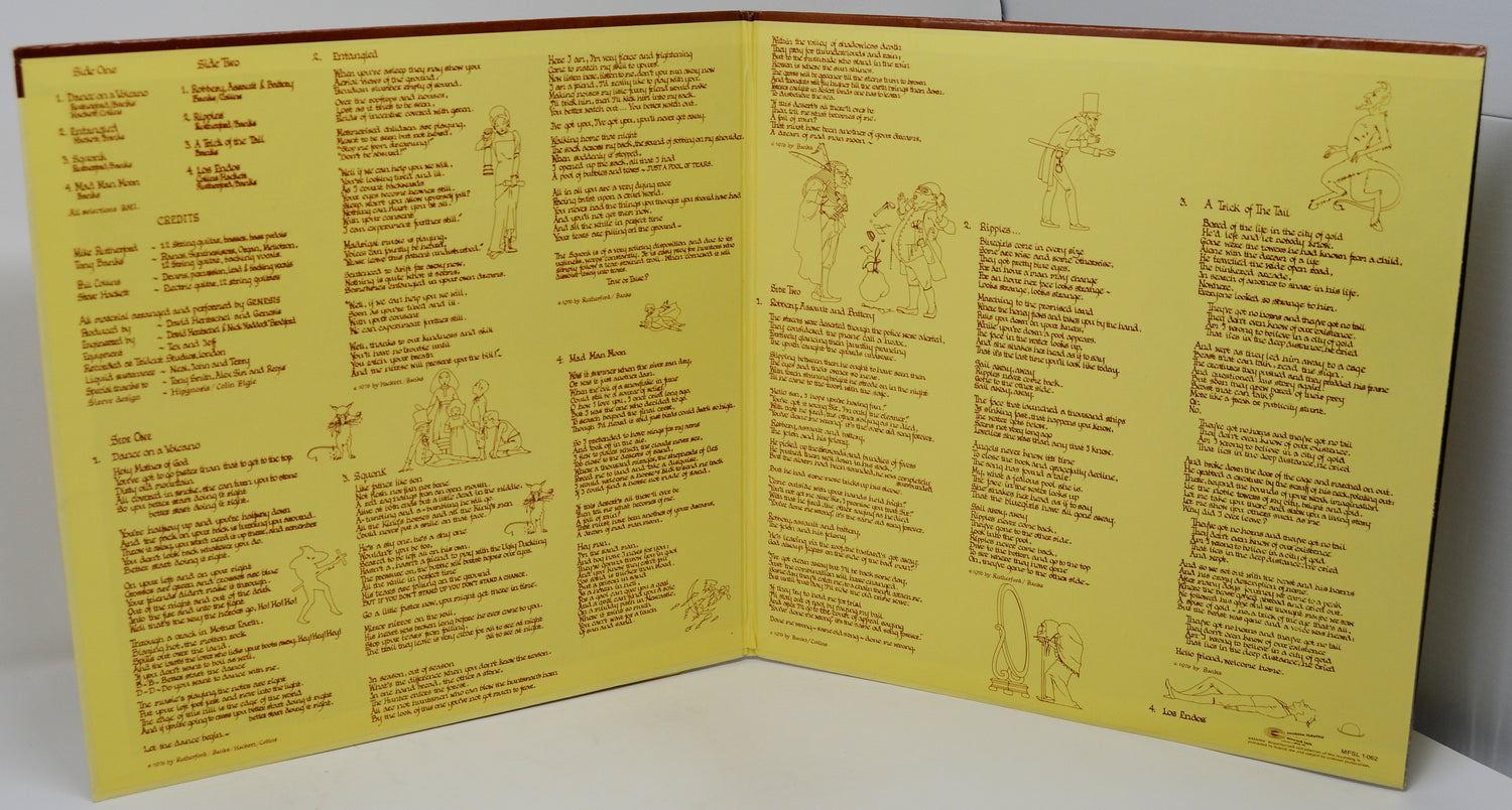 Open book with yellow pages containing text and illustrations on a white surface.