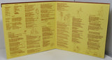 Open book with yellow pages containing text and illustrations on a white surface.