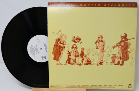 Vinyl record with a colorful cover featuring illustrations of people and animals on a light green background.