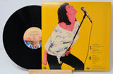 Back cover and vinyl record of Genya Ravan’s ...And I Mean It! album, showing tracklist and colorful graphic design