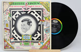 Vinyl record with colorful cover featuring a portrait and text