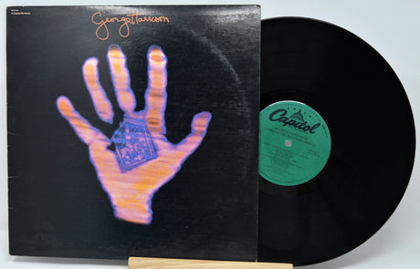 Vinyl record with a hand illustration on the cover and 'Capitol' label.