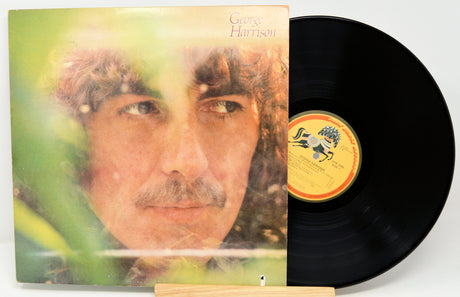 Vinyl record with cover featuring a person's face and album details.