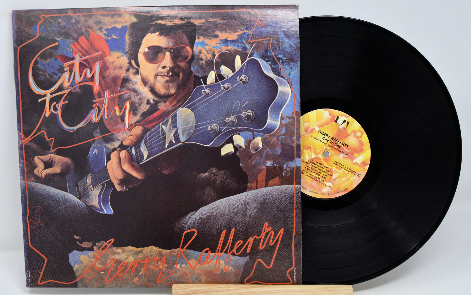 Used vinyl record of Gerry Rafferty, City To City, with album cover art featuring a man with sunglasses and a guitar.