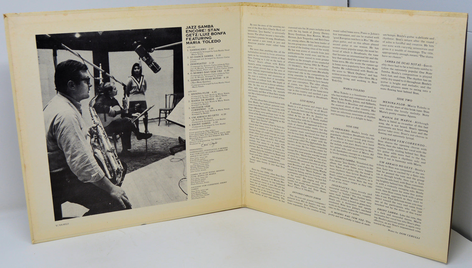 Open book with a black and white photo on the left and text on the right.