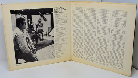 Open book with a black and white photo on the left and text on the right.