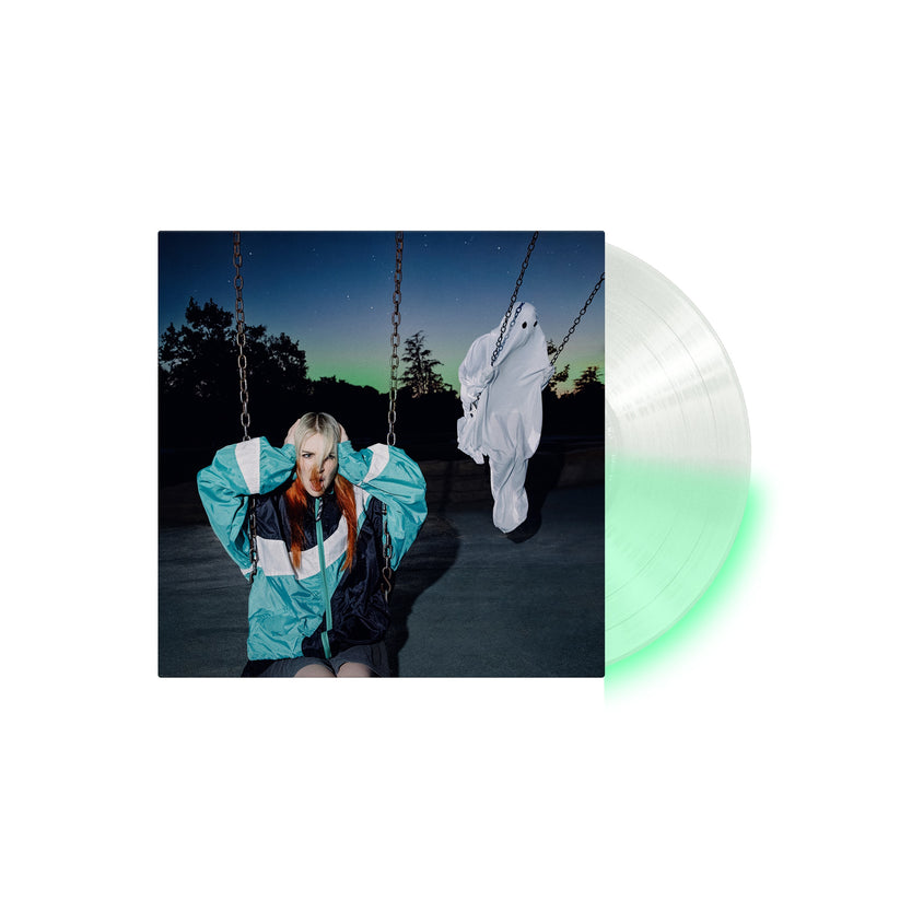Clear vinyl record with a cover showing a woman in a teal jacket on a swing and a ghost figure at dusk