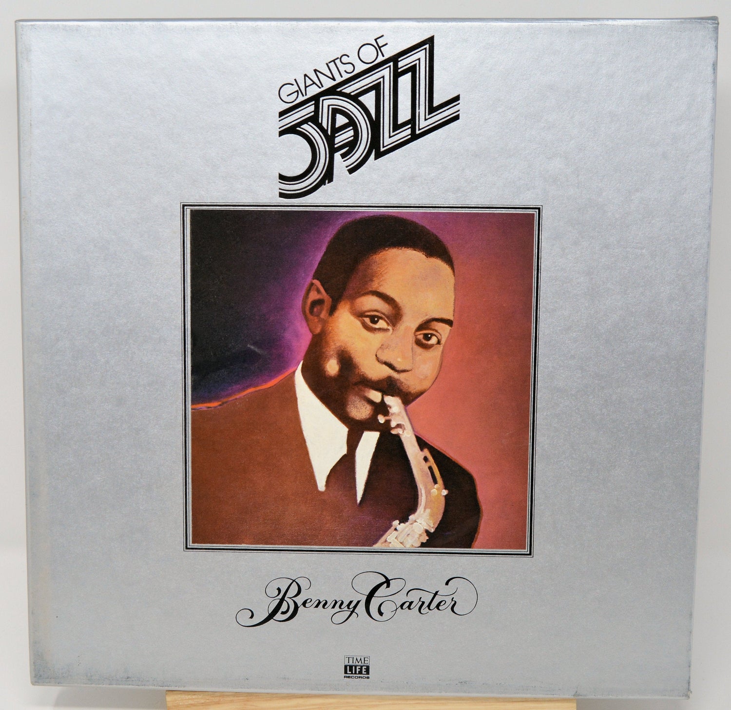 Illustrated album cover of Benny Carter, Giants of Jazz, playing saxophone