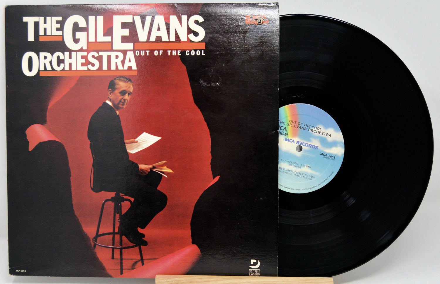 Front cover of Out of the Cool vinyl LP by Gil Evans Orchestra, showing Gil Evans seated with sheet music