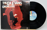 Front cover of Out of the Cool vinyl LP by Gil Evans Orchestra, showing Gil Evans seated with sheet music