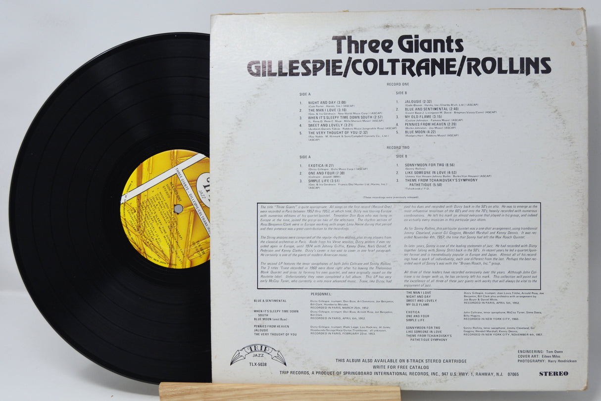 Vinyl record with cover displaying 'Three Giants' by Gillespie/Coltrane/Rollins on a white background.