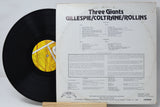 Vinyl record with cover displaying 'Three Giants' by Gillespie/Coltrane/Rollins on a white background.