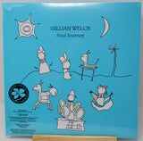 Gillian Welch - Soul Journey vinyl record cover, showing the blue back of the sleeve with hand-drawn black line illustrations and text, displayed on a wooden stand.