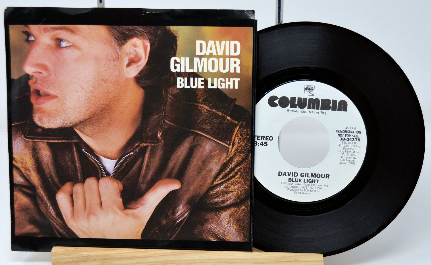 Vinyl record and cover of 'Blue Light' by David Gilmour on a white background