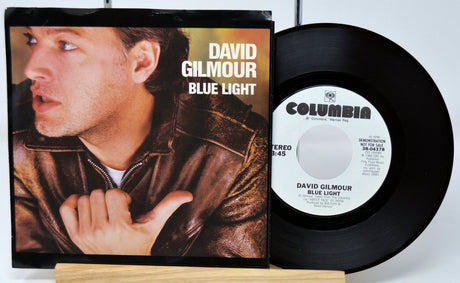 Vinyl record and cover of 'Blue Light' by David Gilmour on a white background