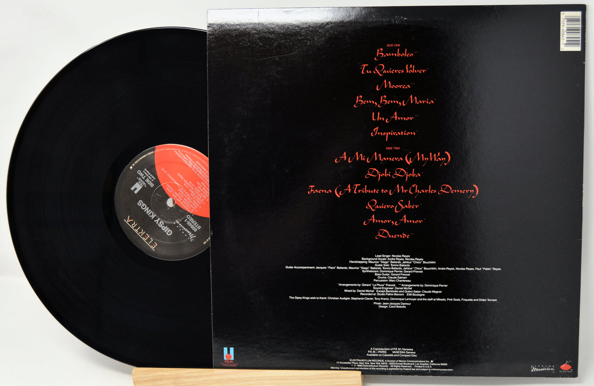 Vinyl record with cover displaying tracklist on a white background