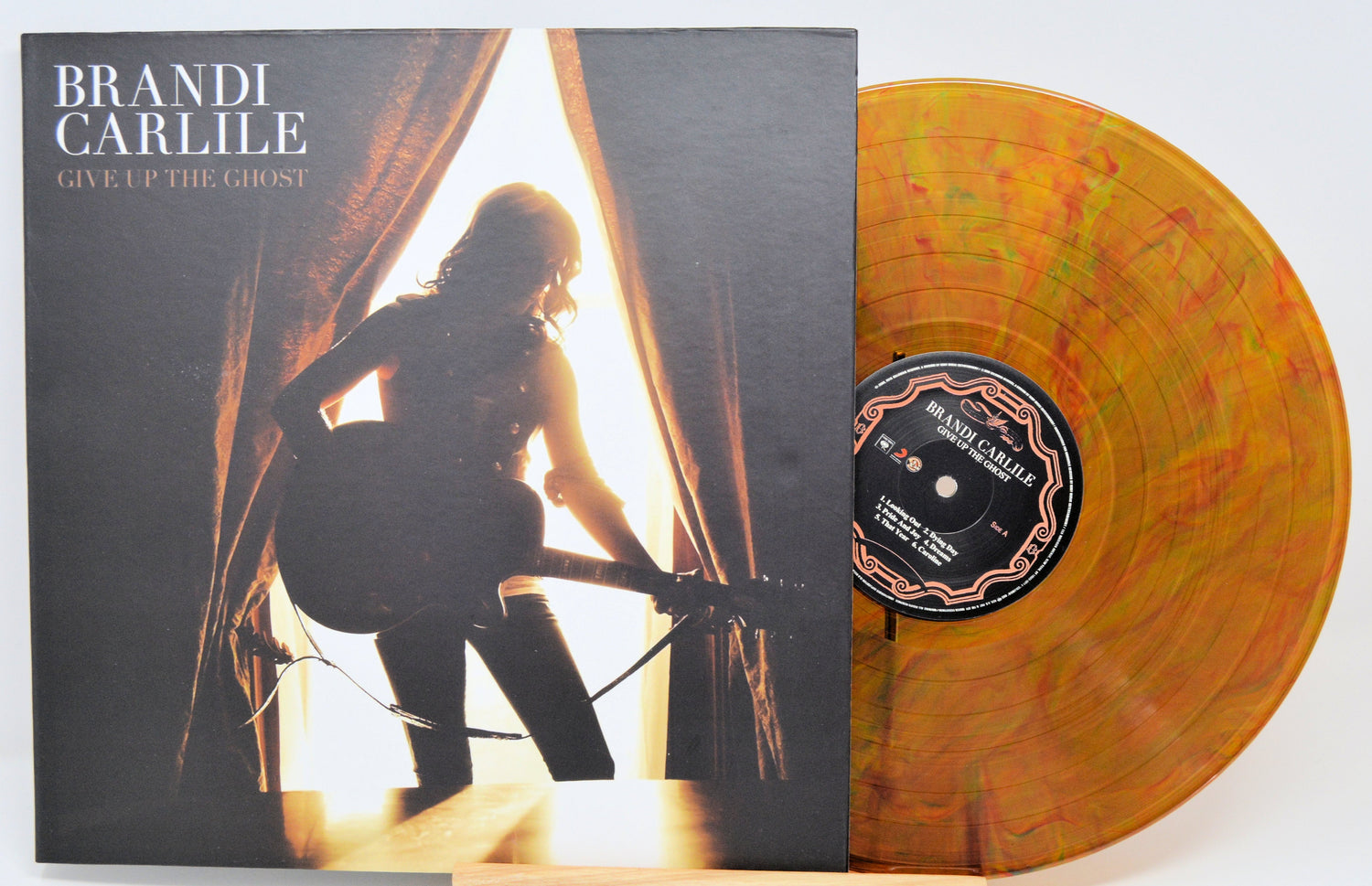 Give Up The Ghost vinyl album cover with silhouette of Brandi Carlile and orange swirl record