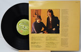 Vinyl record with yellow cover featuring two individuals and text