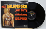 Vinyl record with 'Goldfinger' soundtrack cover featuring James Bond imagery.