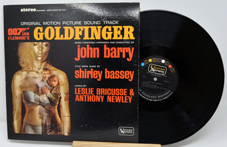 Vinyl record with 'Goldfinger' soundtrack cover featuring James Bond imagery.