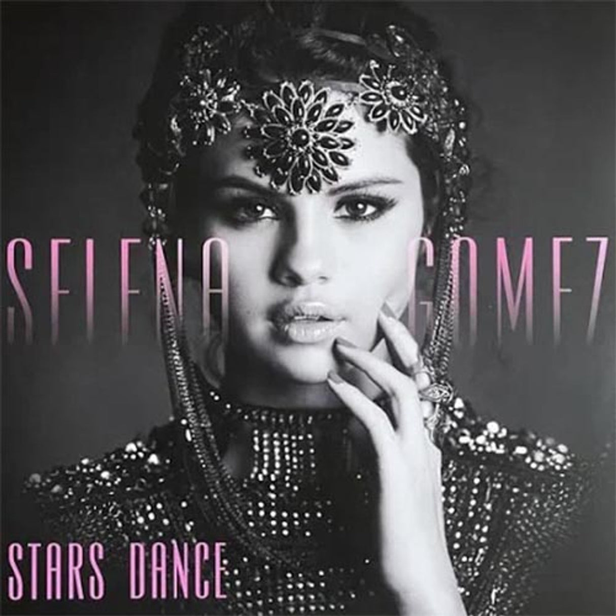 Black and white album cover of Selena Gomez with a floral headpiece, wearing a beaded outfit, with the text 'STELLA GOMEZ STARS DANCE' on the top and bottom.