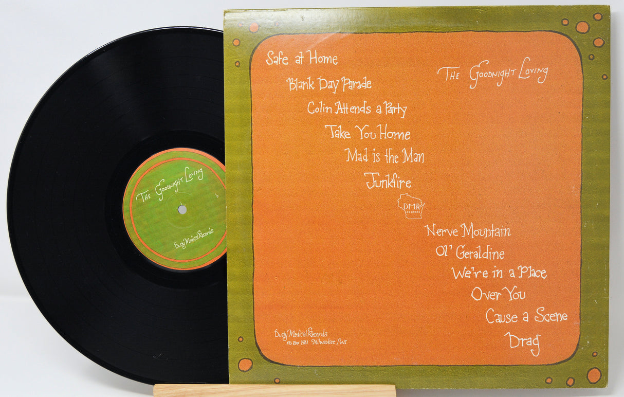 Vinyl record with orange cover featuring song titles on a white background